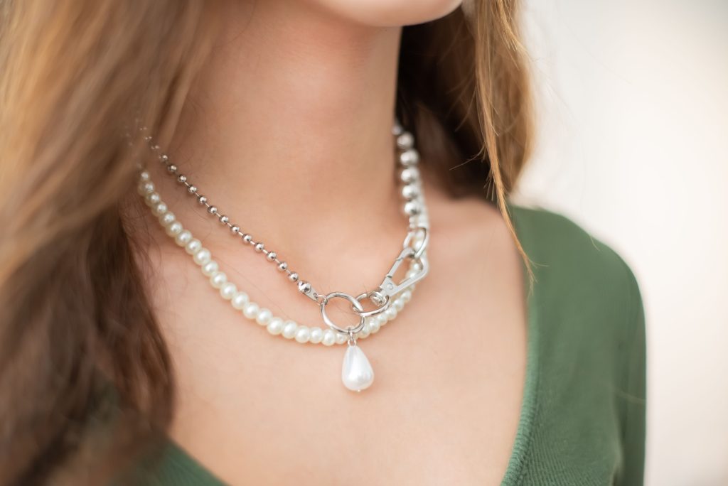 Close-up of a woman's neck adorned with elegant layered pearl necklaces.